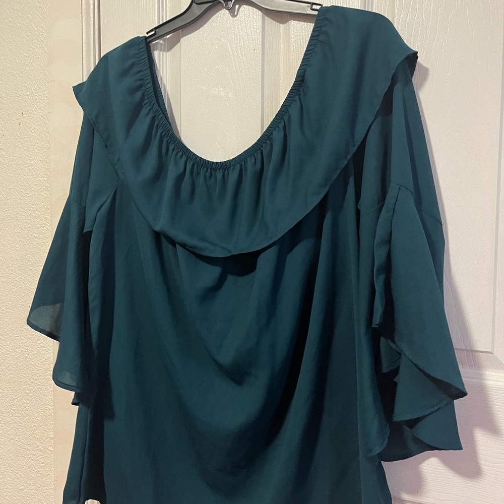 It’s a teal off the shoulder blouse perfect for the Fall.
